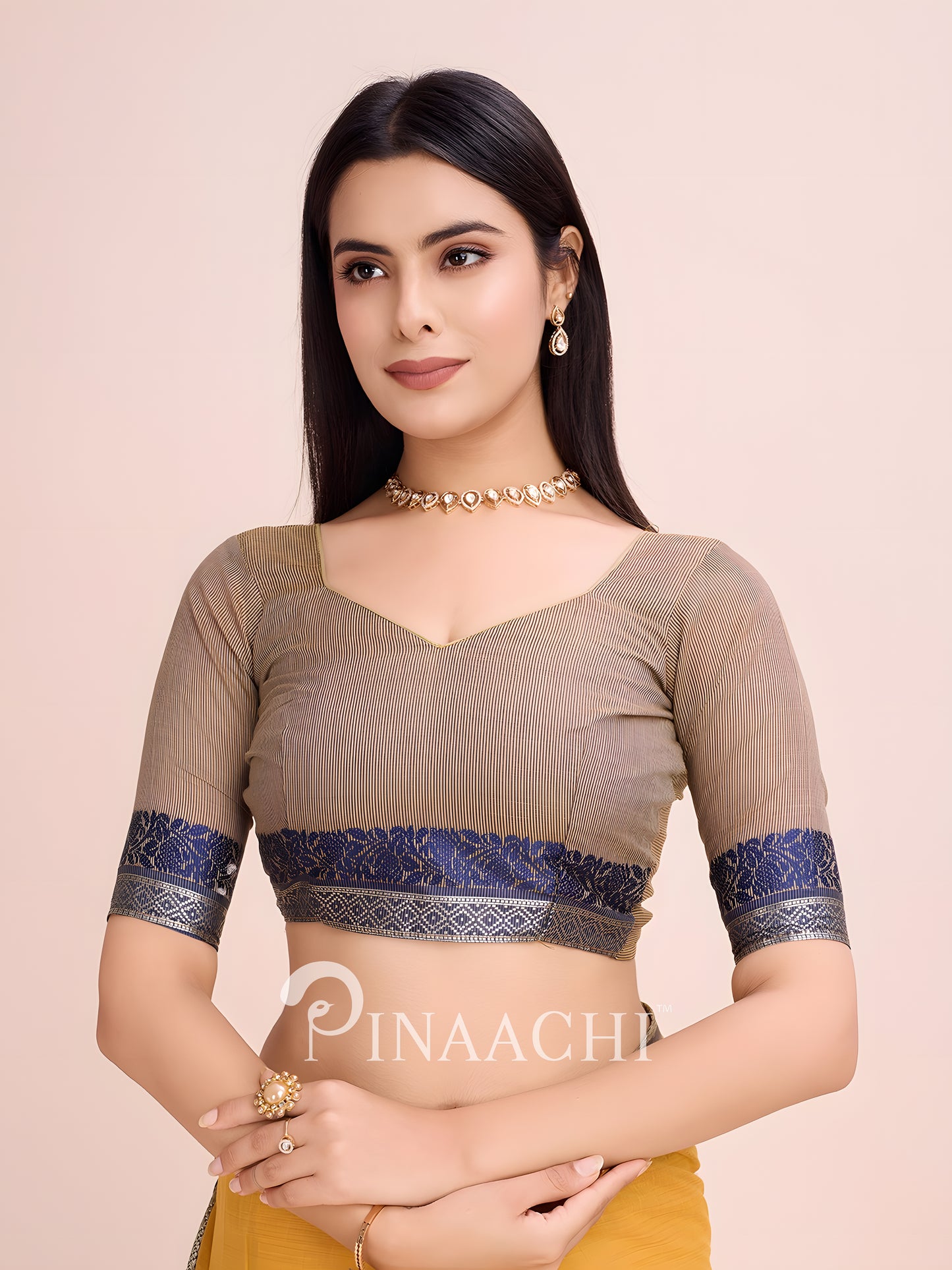 Elegant model wearing a mustard cotton saree with woven border and stylish blouse for festive occasions