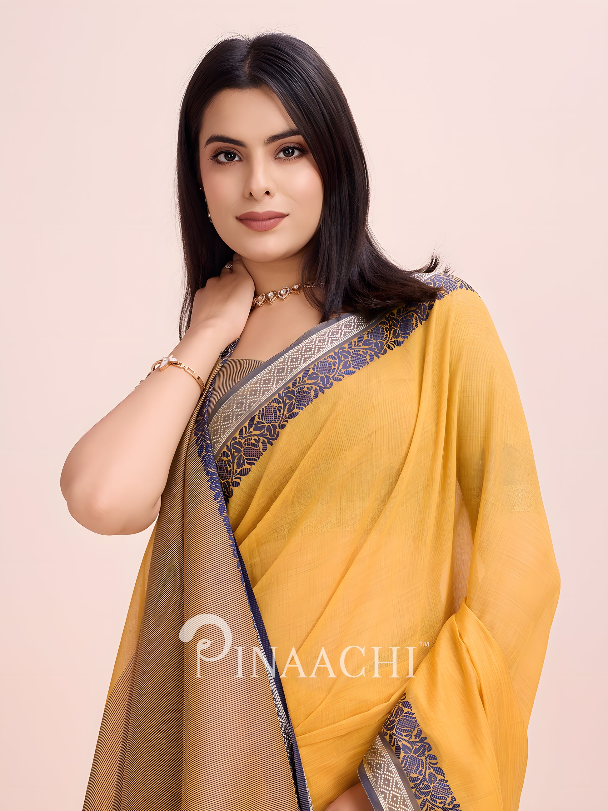 Elegant mustard cotton saree with woven border, beautifully styled for a sophisticated look