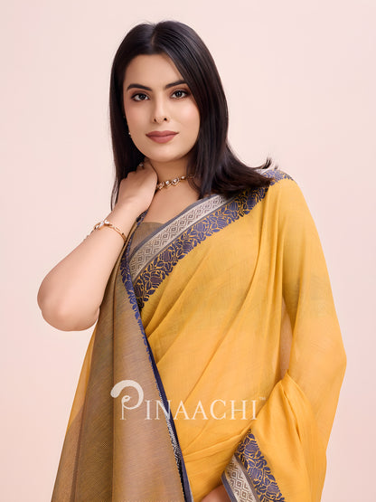 Elegant mustard cotton saree with woven border, beautifully styled for a sophisticated look