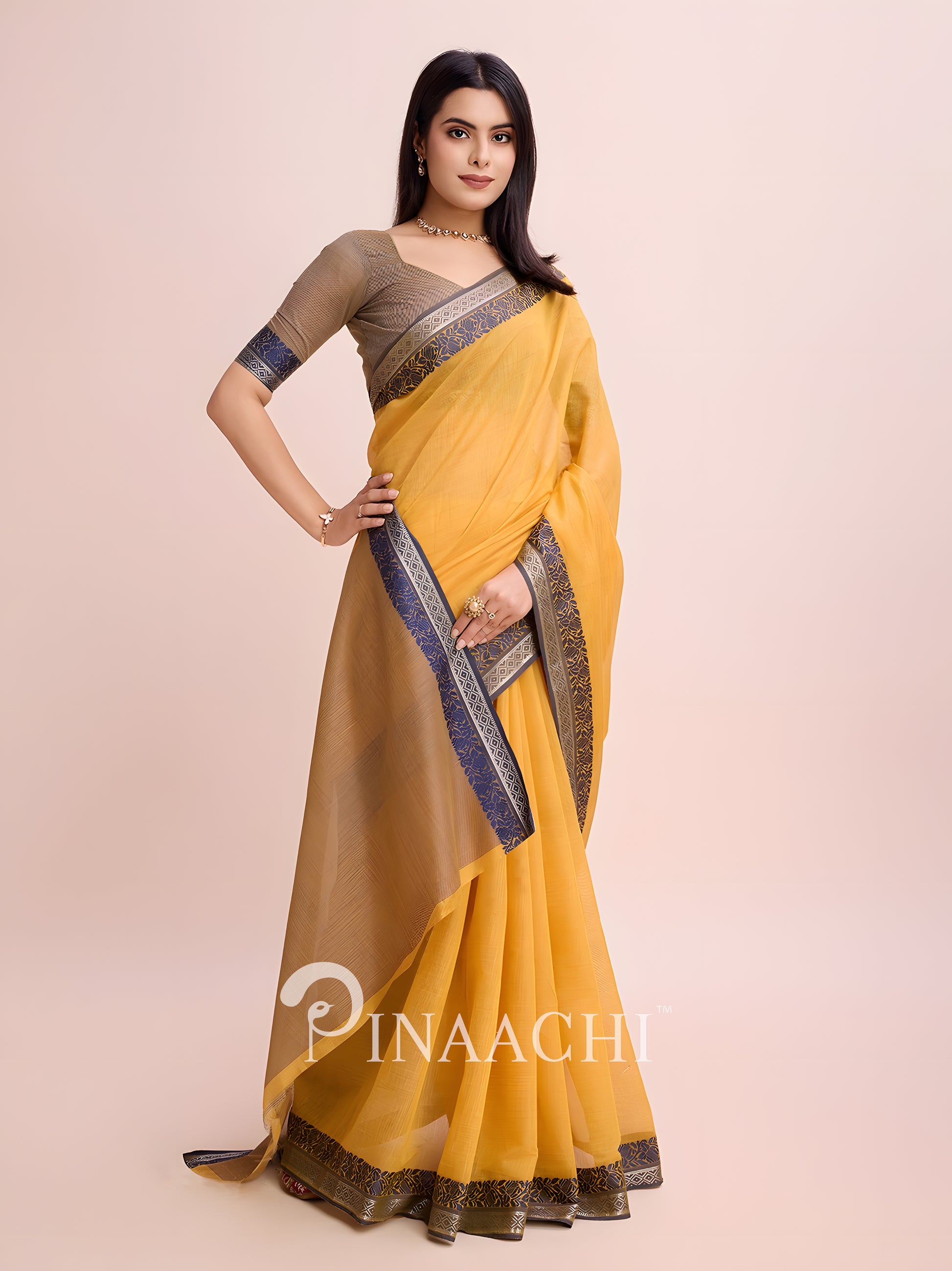 Elegant mustard cotton saree with woven border styled beautifully for festive occasions