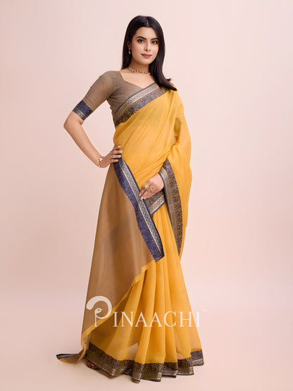 Elegant mustard cotton saree with woven border styled beautifully for festive occasions