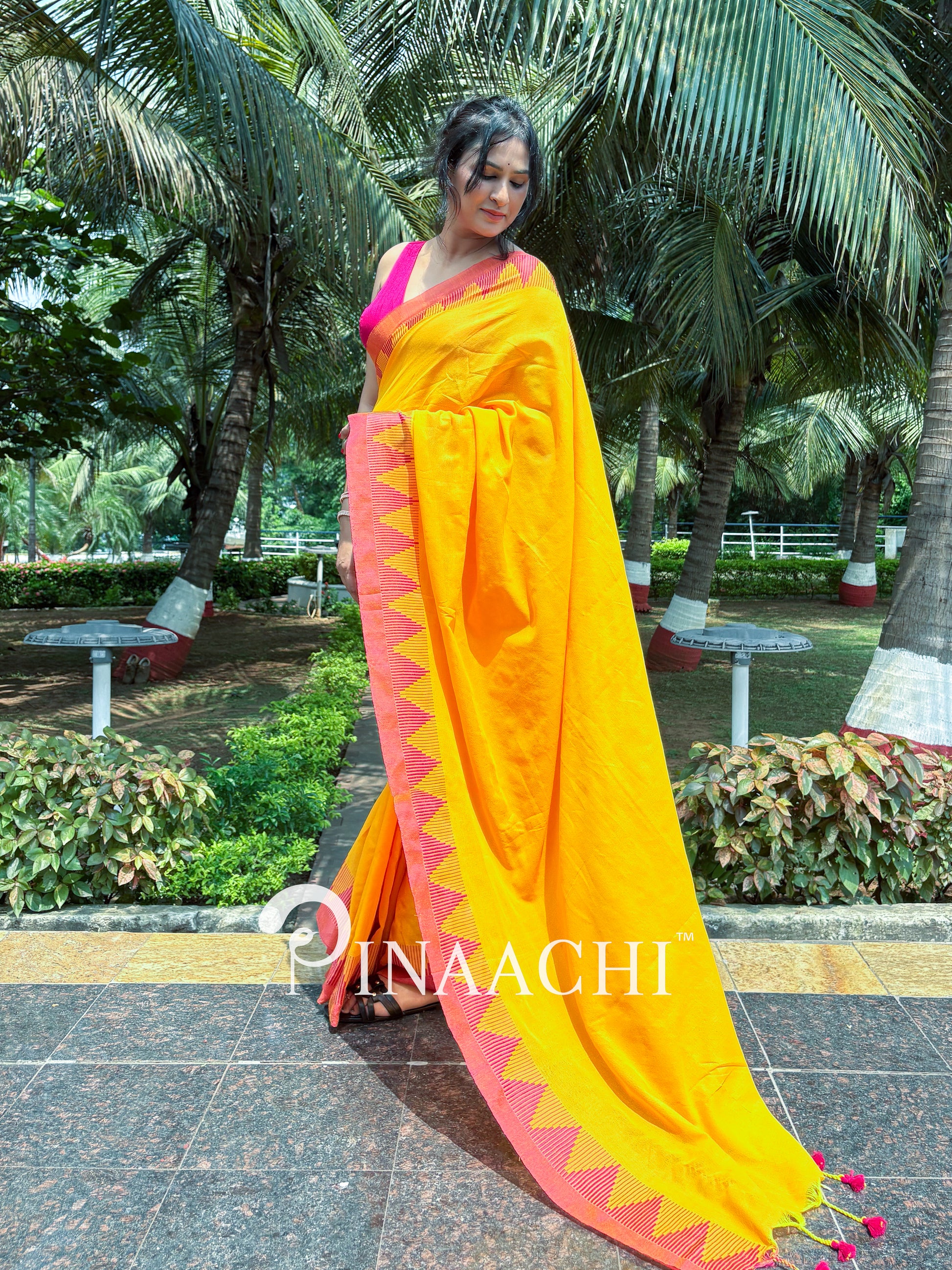 Stylish mustard yellow cotton saree with vibrant pink border and tassels for elegant occasions