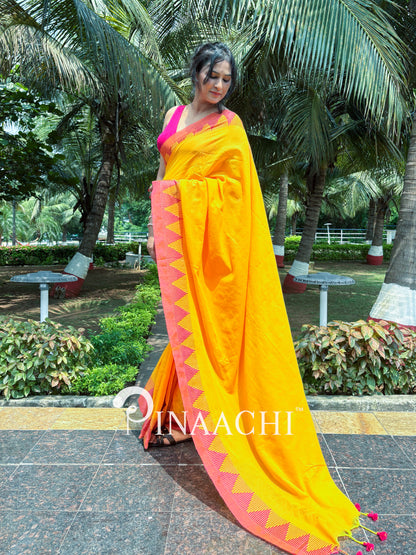 Stylish mustard yellow cotton saree with vibrant pink border and tassels for elegant occasions