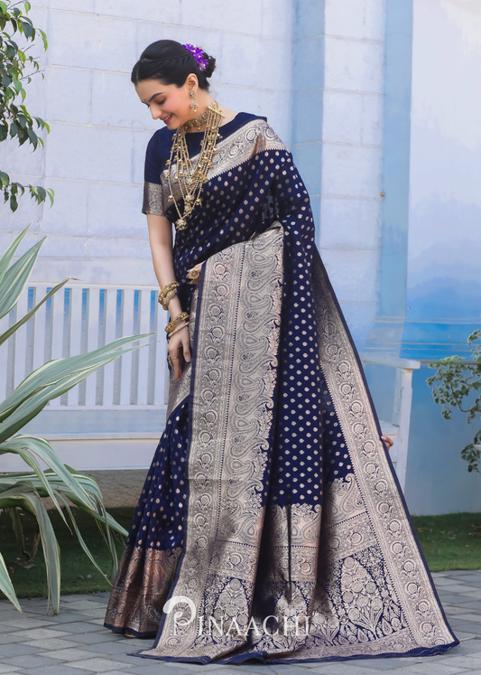 Pinaachi Navy Blue Banarasi Silk Saree worn by a woman with intricate silver zari work and traditional patterns