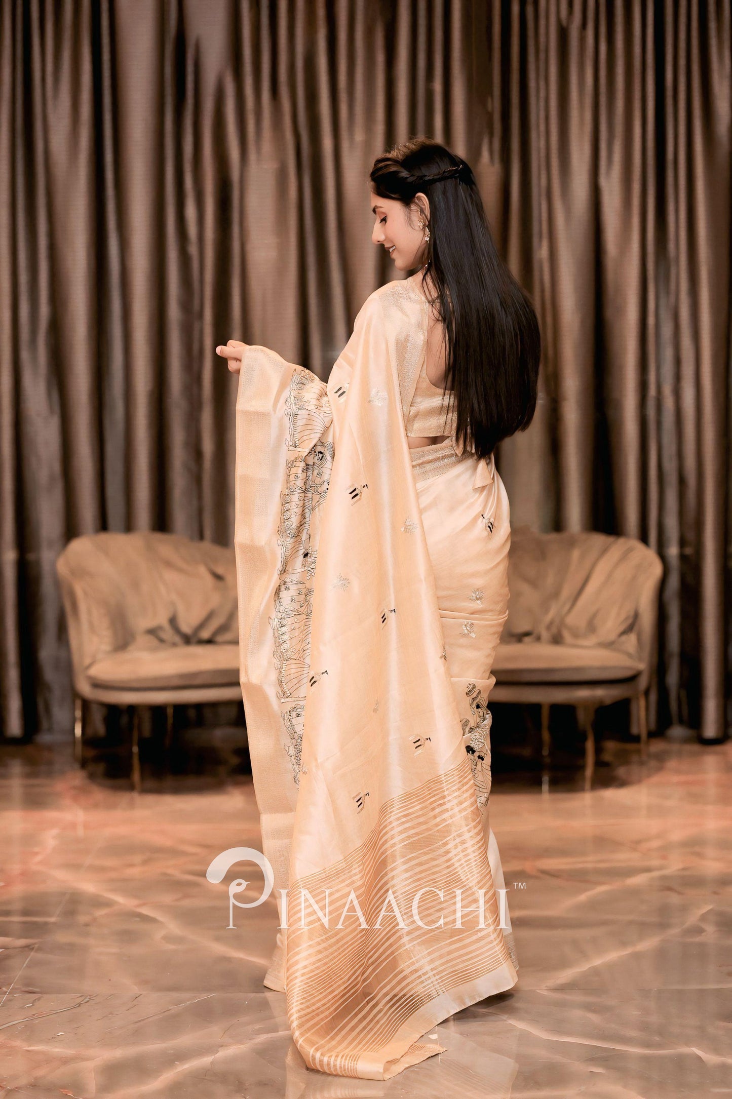 Elegant off-white tussar silk saree by Pinaachi, featuring intricate designs and a graceful drape