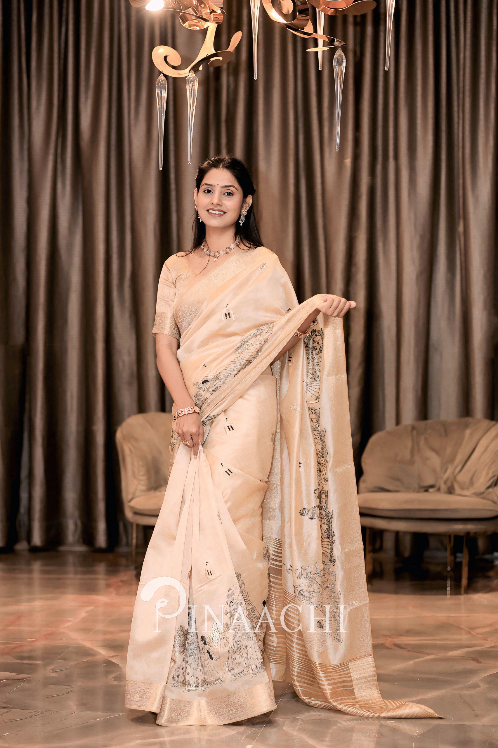 Elegant off-white tussar silk saree by Pinaachi with intricate detailing and shimmering fabric