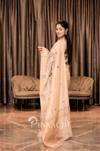 Elegant off-white tussar silk saree from Pinaachi, showcasing intricate designs and draping style