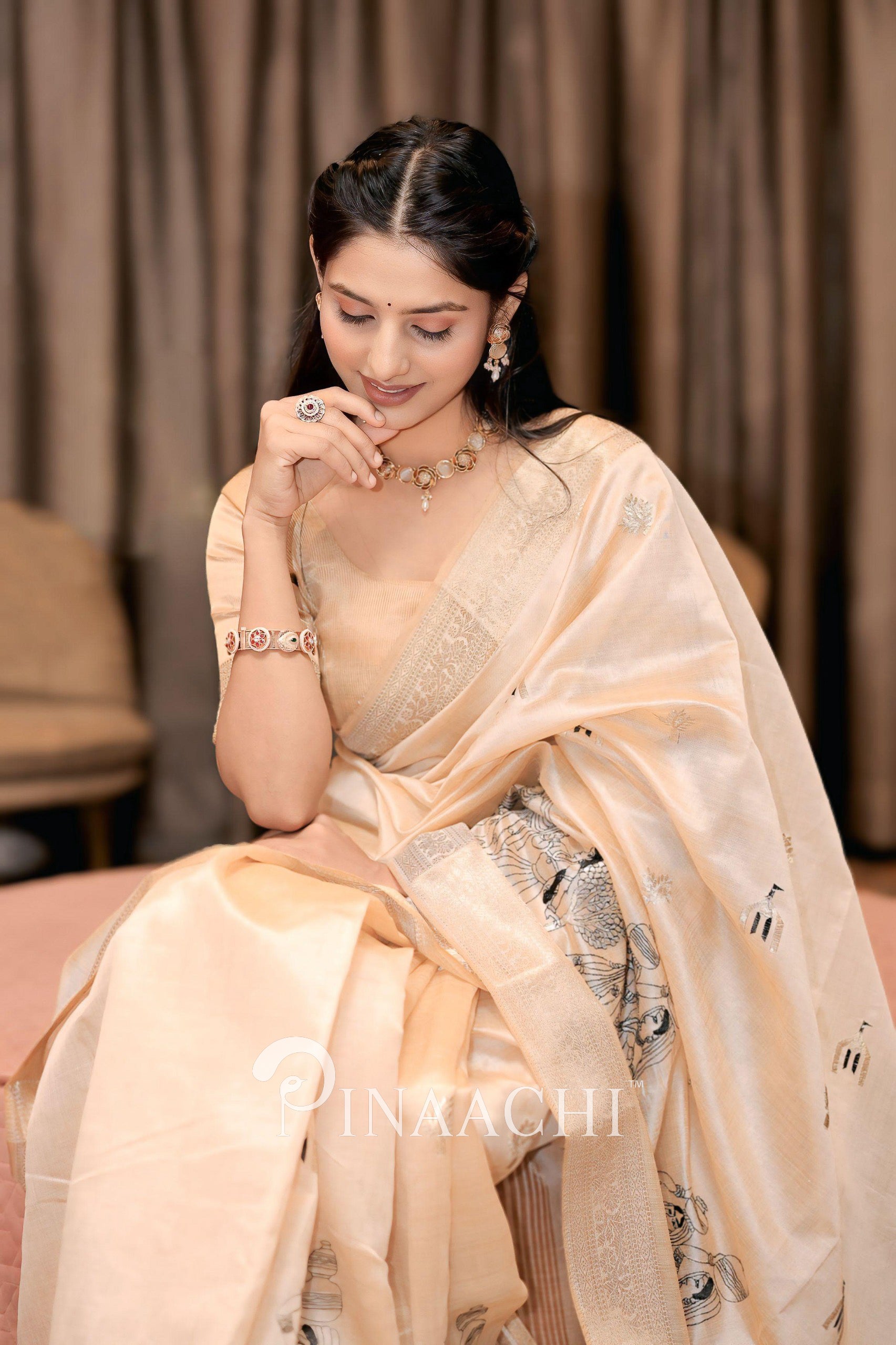 Elegant off-white tussar silk saree draped gracefully with intricate detailing for special occasions