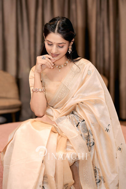 Elegant off-white tussar silk saree draped gracefully with intricate detailing for special occasions