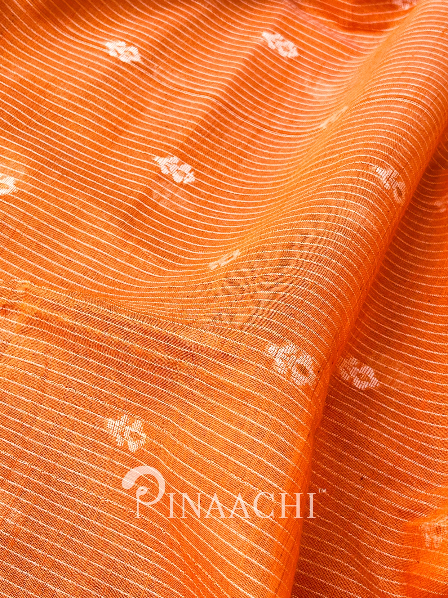 Pinaachi orange cotton silk jamdani saree with intricate floral patterns and fine textures