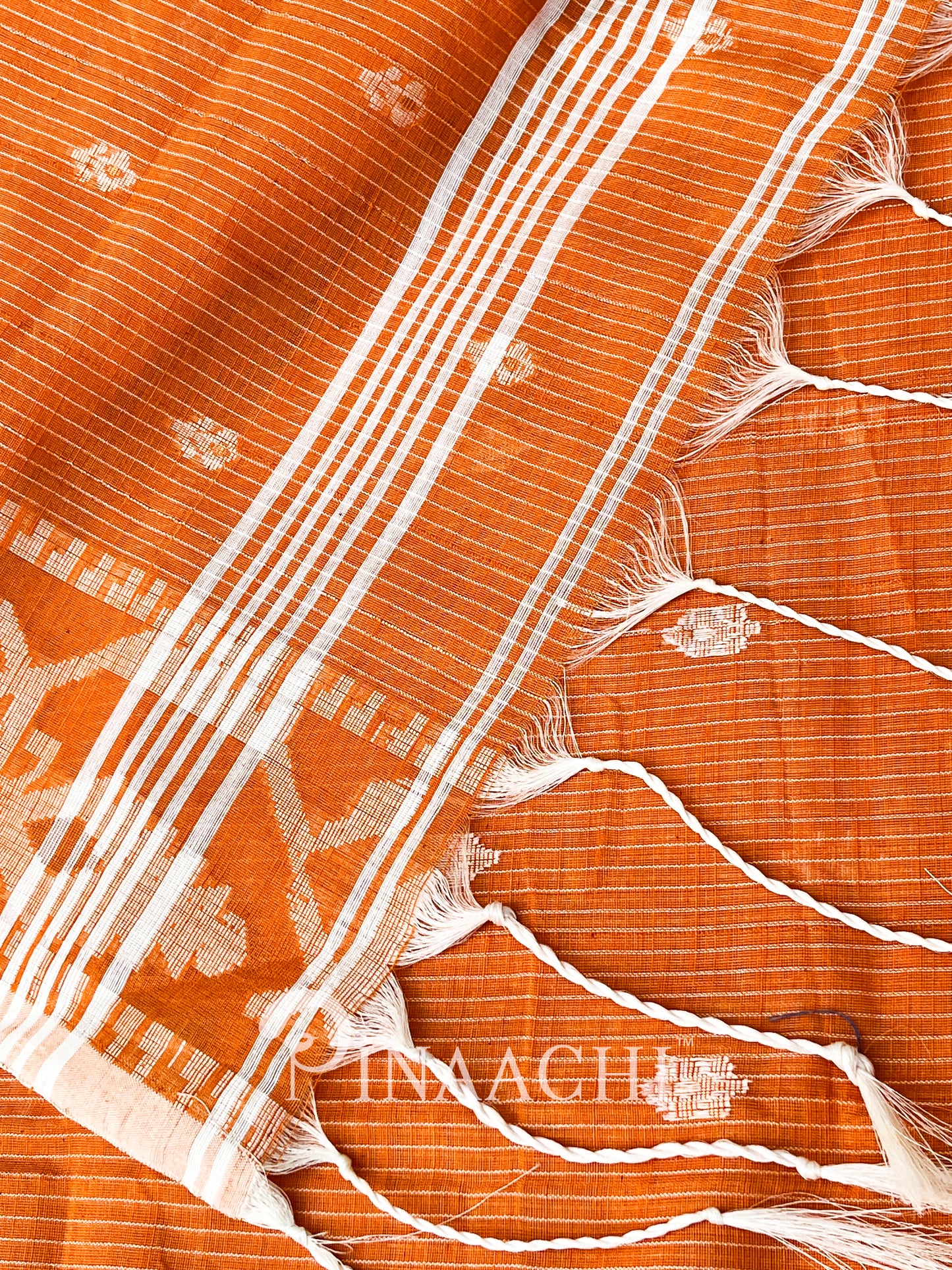 Pinaachi orange cotton silk jamdani saree with traditional patterns and delicate fringes