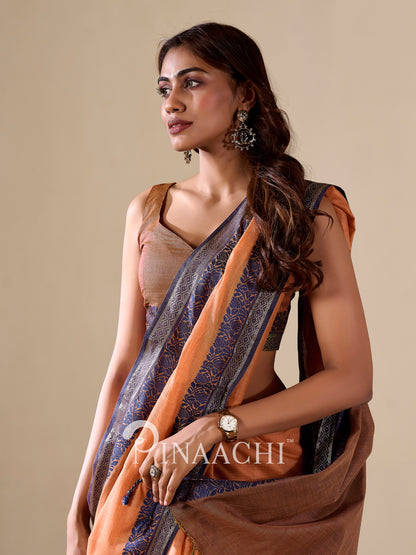 Elegant orange cotton silk saree adorned with intricate patterns for festive occasions