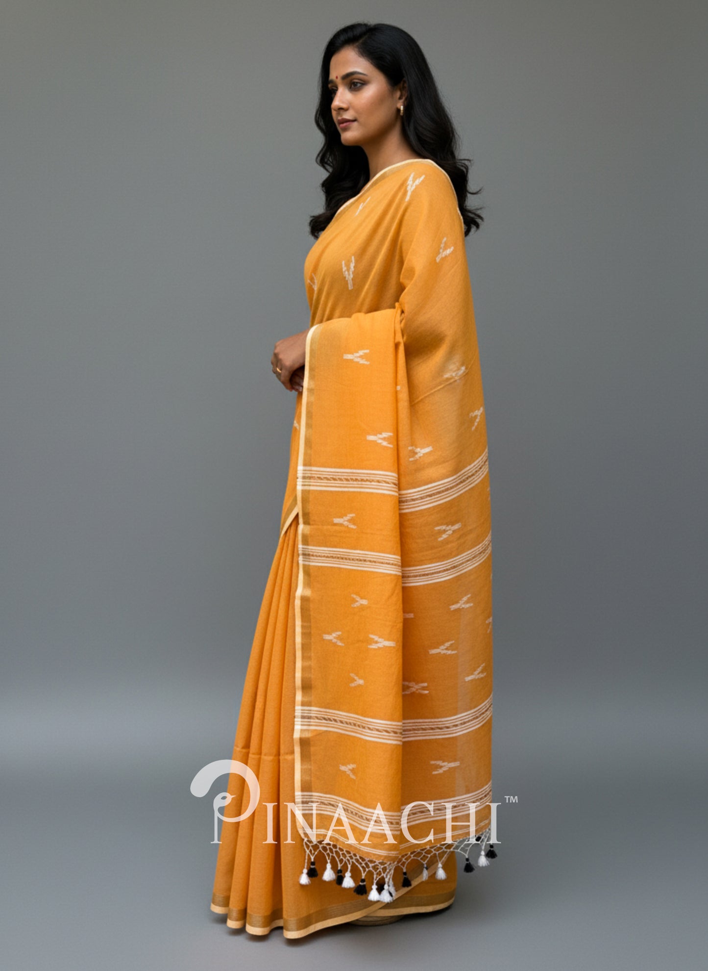 Pinaachi orange mulmul jamdani saree with intricate patterns and tassels for elegant wear