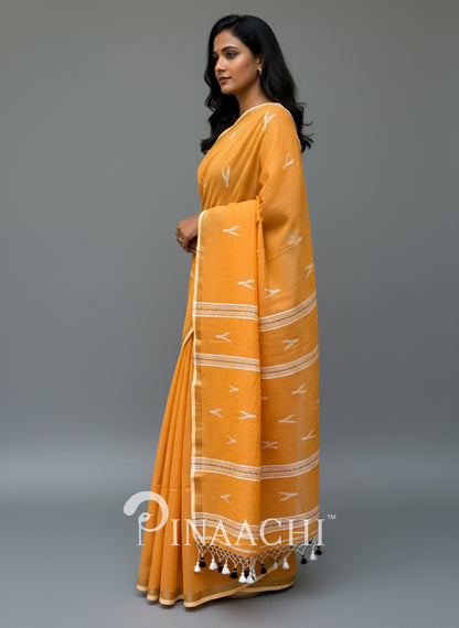 Pinaachi orange mulmul jamdani saree with intricate patterns and tassels for elegant wear