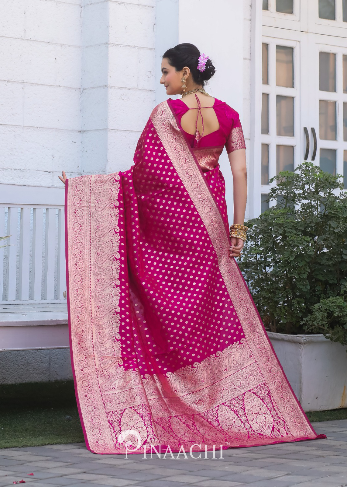 Woman wearing Pinaachi Pink Banarasi Silk Saree with intricate gold zari work and traditional design