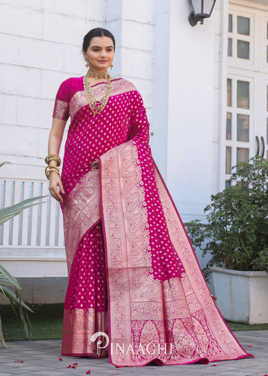 Woman wearing Pinaachi Pink Banarasi Silk Saree with intricate golden patterns and traditional jewelry