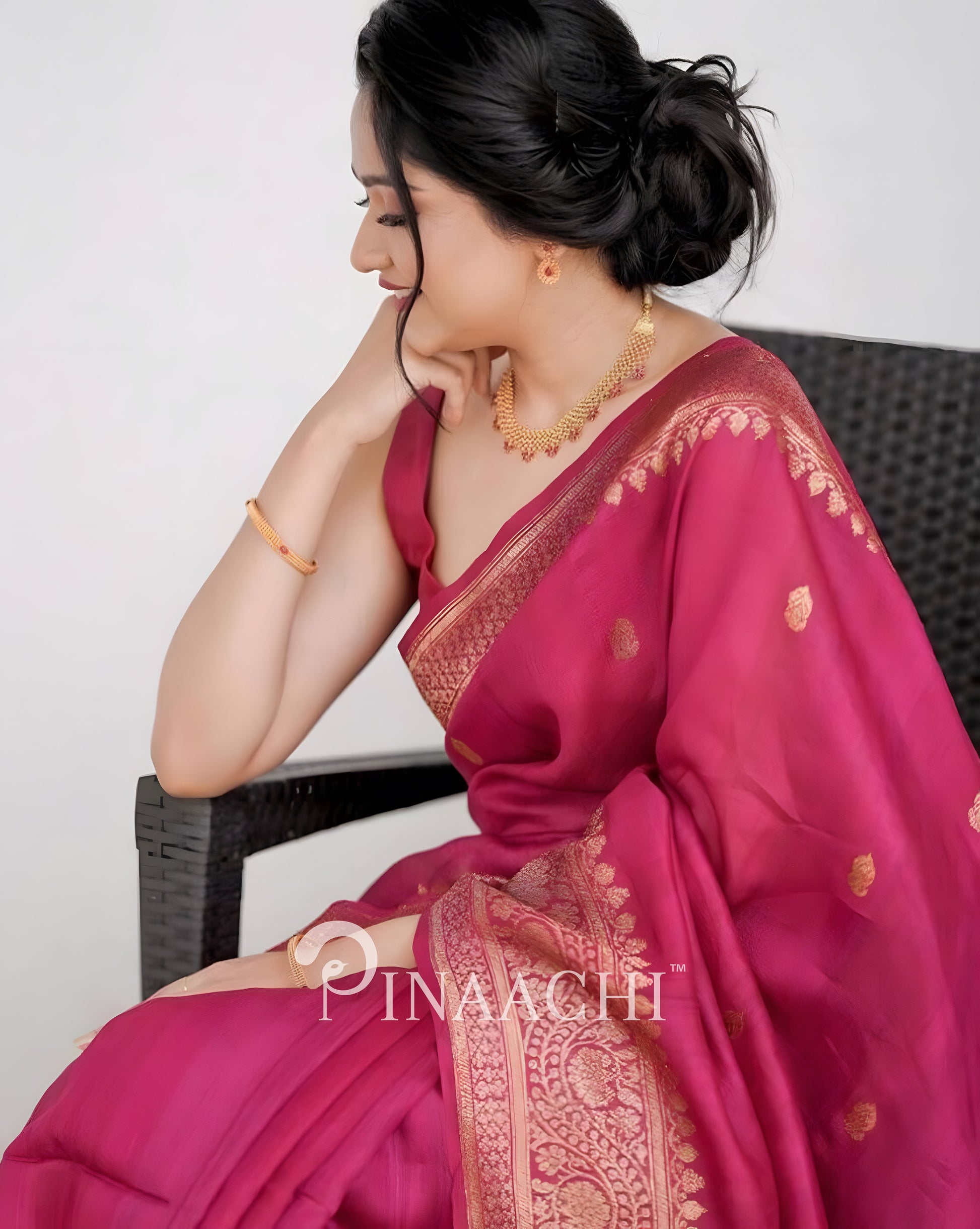 Elegant pink litchi silk saree from Pinaachi with intricate gold detailing, perfect for festive occasions