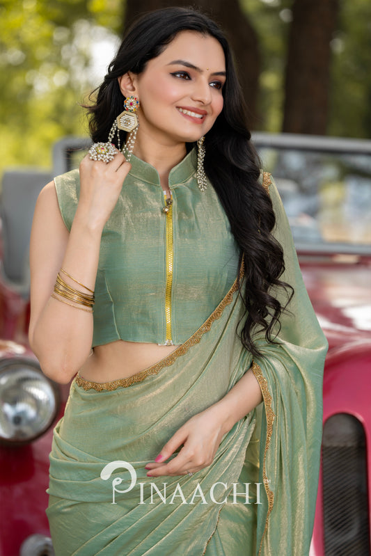 Pinaachi pista green chiffon saree worn by woman with gold choli and statement earrings