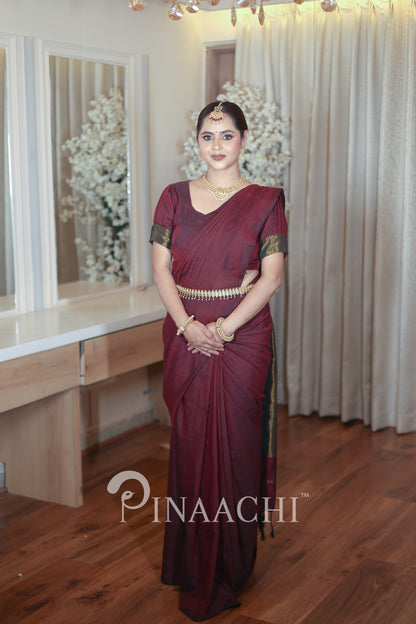 Elegant plum wine cotton saree handspun draped beautifully on a model with traditional accessories