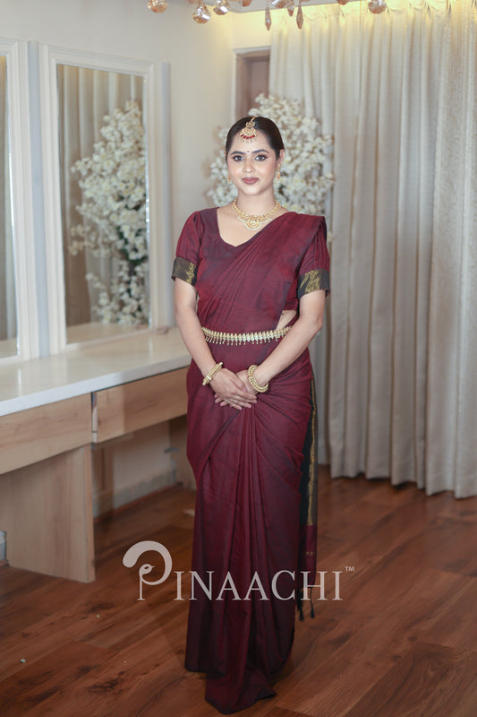Elegant plum wine cotton saree handspun draped beautifully on a model with traditional accessories