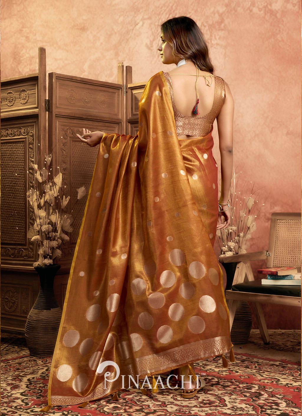 Pinaachi polka tissue silk saree in golden brown with large polka dots worn by model showing back design