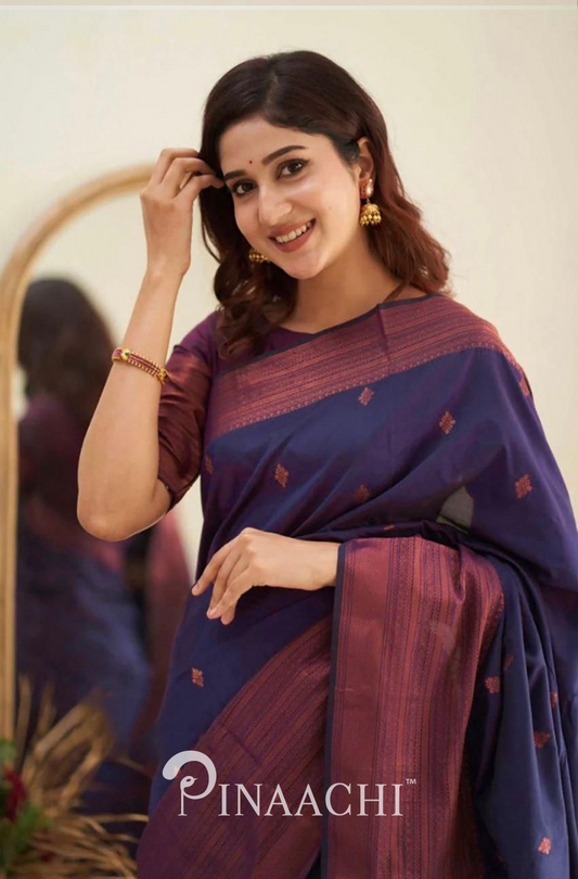 Pinaachi Purple Litchi Silk Saree draped elegantly on a smiling woman with gold jewelry