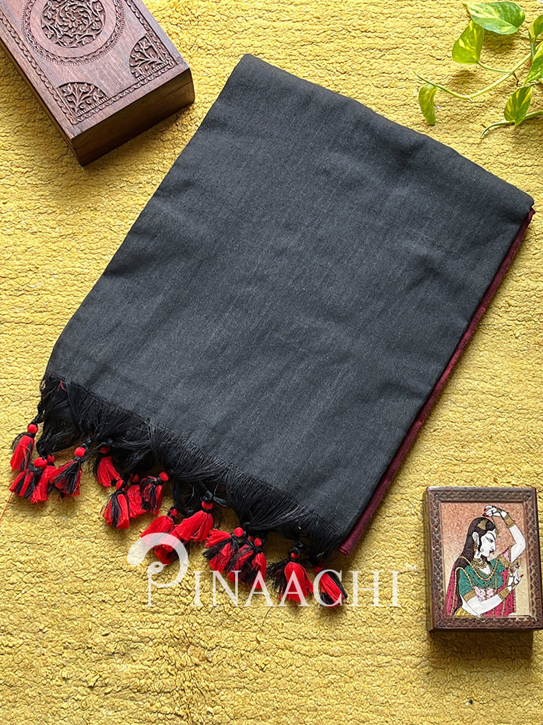 Elegant red dual color cotton saree with intricate black detailing and decorative tassels