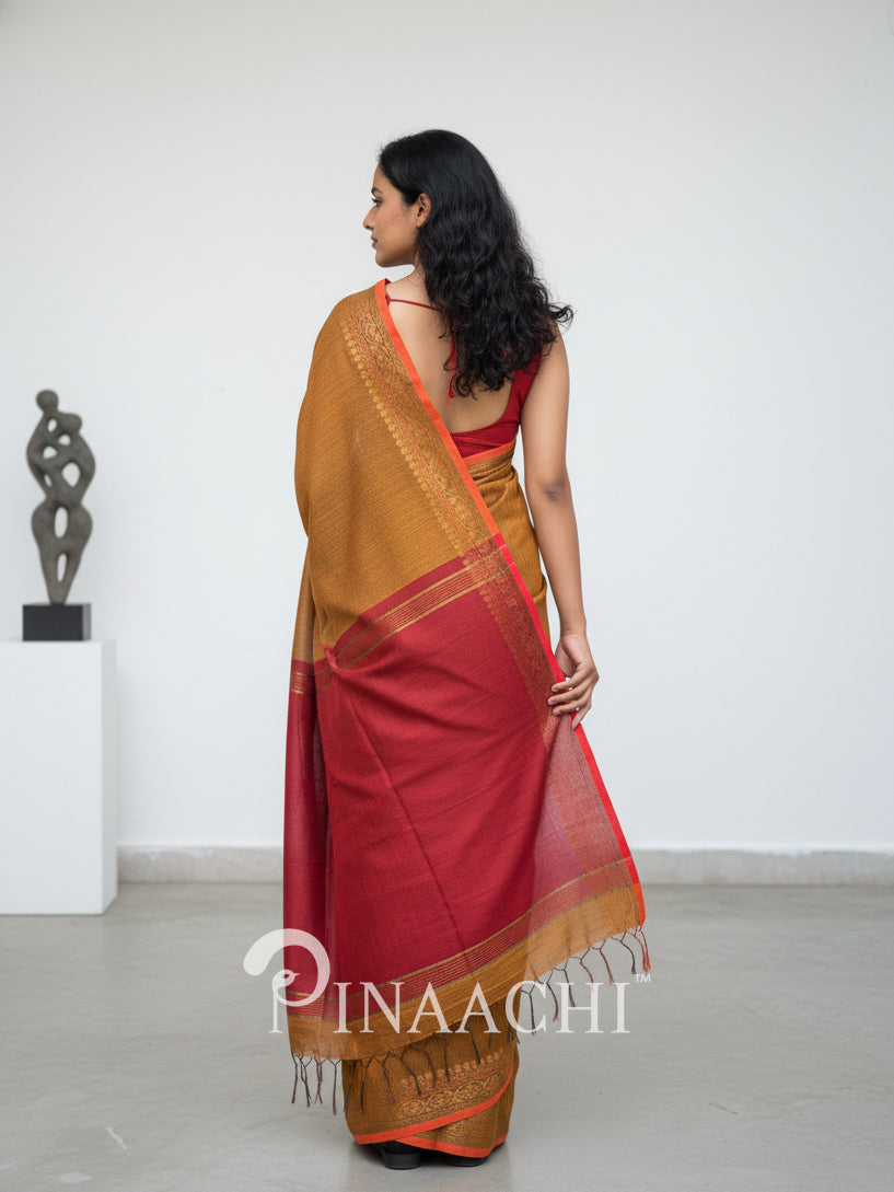Pinaachi smoked mustard cotton silk saree with elegant draping and traditional tassel detailing