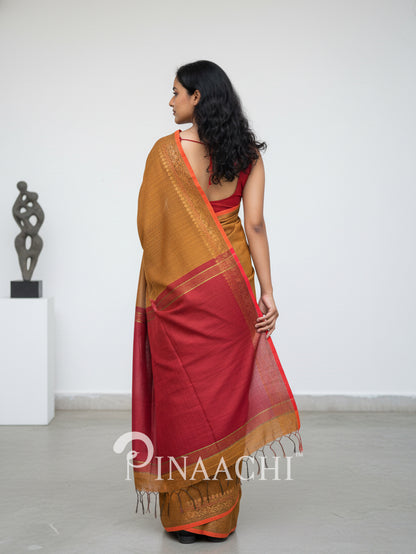 Pinaachi smoked mustard cotton silk saree with elegant draping and traditional tassel detailing