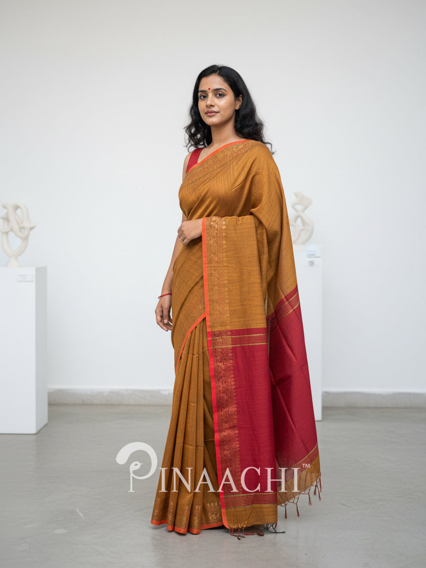 Pinaachi smoked mustard cotton silk saree with red border and elegant draping style