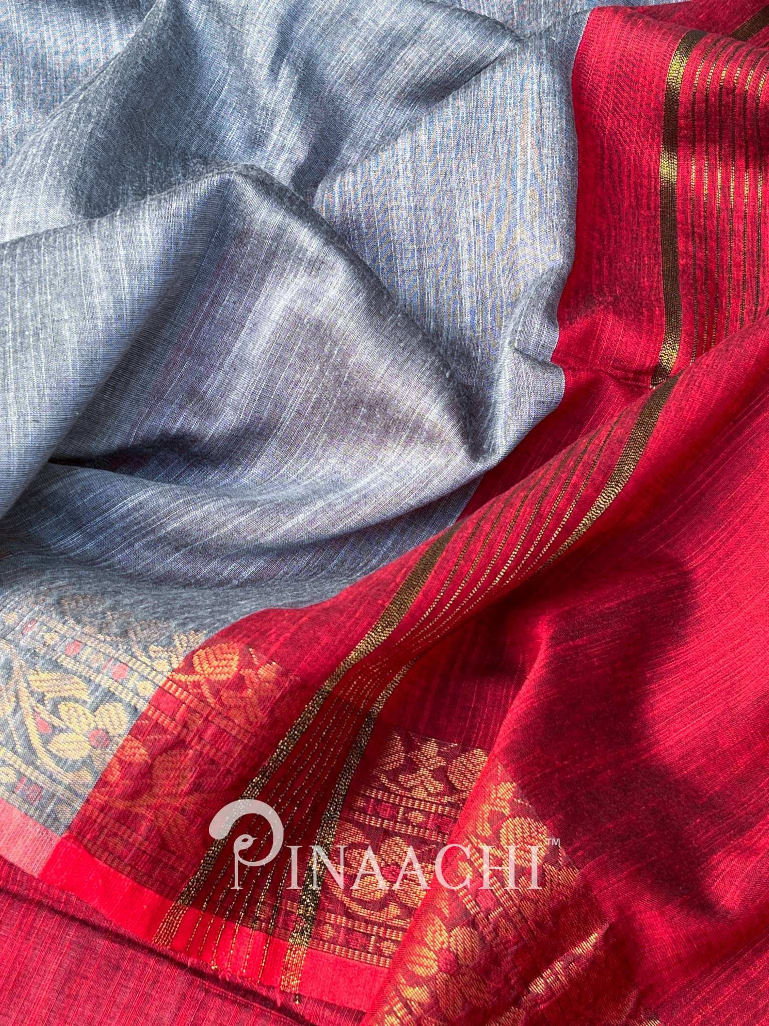Pinaachi steel blue cotton silk saree with intricate red border and floral designs
