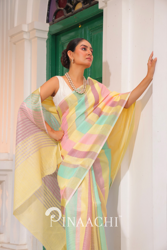 Woman wearing Pinaachi Summer Stripe Linen Silk Saree in pastel multicolor stripes posing indoors