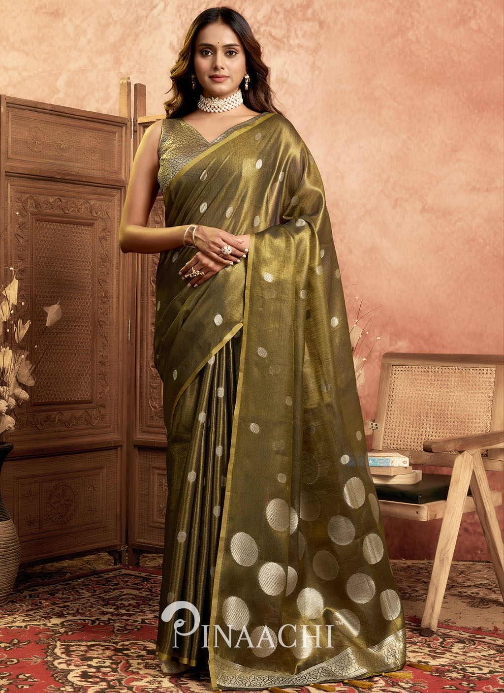 Elegant olive green pinaachi tissue silk saree online with polka dot design worn by model