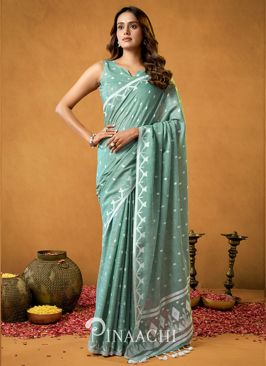 Woman wearing Pinaachi Rama Cotton Jamdani Saree in soft green with white woven patterns and border