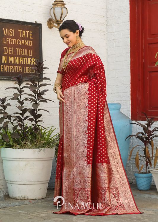 Pinaachi Red Banarasi Silk Saree with intricate gold zari work worn by a woman in traditional style